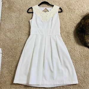 White dress with cream lace collar and back cutout